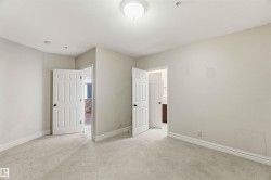 This room features light-colored carpeting, white baseboards, and neutral wall paint - 