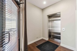 Entryway featuring direct elevator access, hardwood flooring, and a large window - 