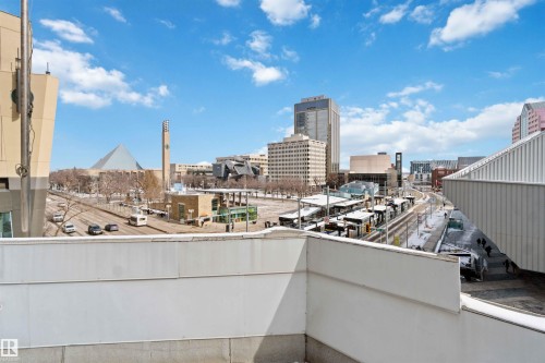 The property offers expansive views of the surrounding urban landscape, showcasing various buildings and street activity - 401 10009 102 Avenue, Edmonton, AB - Outdoor