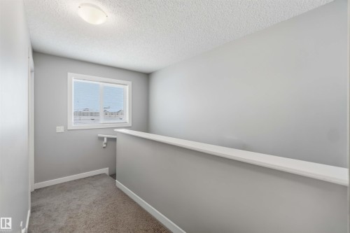 This area features a window, gray walls, and carpeted flooring - 1313 Chappelle Boulevard, Edmonton, AB - Indoor Photo Showing Other Room