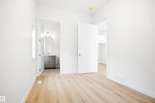 The property features light-toned flooring, white walls, and white trim - 9807 90 Avenue, Edmonton, AB - Indoor Photo Showing Other Room