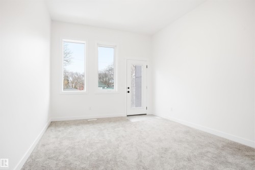 This room features light-colored carpeting, white walls, and white baseboards - 9807 90 Avenue, Edmonton, AB - Indoor Photo Showing Other Room