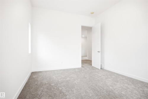 This room features light gray carpeting, white walls, and a recessed ceiling light - 9807 90 Avenue, Edmonton, AB - Indoor Photo Showing Other Room