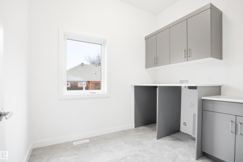 Utility room featuring gray cabinetry, a white countertop, and tiled flooring - 9807 90 Avenue, Edmonton, AB - Indoor Photo Showing Other Room