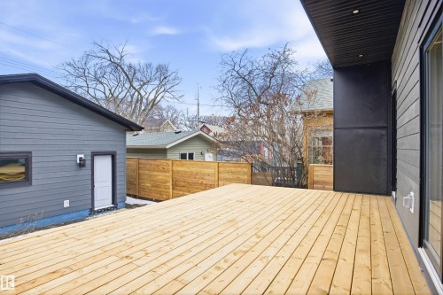 This property features an expansive outdoor deck area with natural wood decking - 9807 90 Avenue, Edmonton, AB - Outdoor With Deck Patio Veranda With Exterior