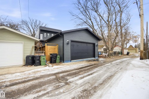 Detached garage with dark siding and a dark garage door - 9807 90 Avenue, Edmonton, AB - Outdoor