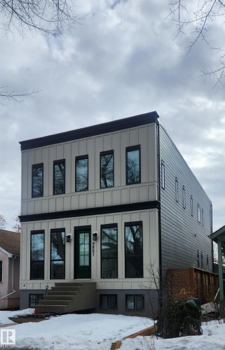 Modern property with a striking exterior, featuring vertical panel siding and a dark trim - 9807 90 Avenue, Edmonton, AB - Outdoor
