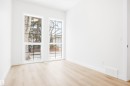 This room features light-toned flooring and white walls, creating a bright and airy atmosphere - 9807 90 Avenue, Edmonton, AB  - Indoor Photo Showing Other Room 