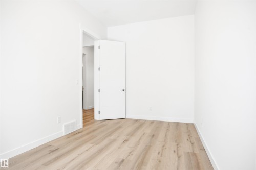 Room with light wood-style flooring and white walls - 9807 90 Avenue, Edmonton, AB - Indoor Photo Showing Other Room