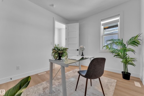 This space features light-toned hardwood flooring, white walls, and a window providing natural light - 110 Eldridge Point(E), St. Albert, AB - Indoor Photo Showing Office