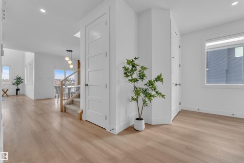The property features light wood flooring, white walls, and white doors, creating a bright and airy atmosphere - 110 Eldridge Point(E), St. Albert, AB - Indoor Photo Showing Other Room