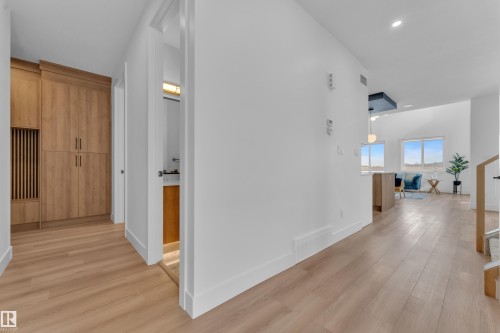 This property features light-toned hardwood flooring throughout, clean white walls, and bright recessed lighting - 110 Eldridge Point(E), St. Albert, AB - Indoor Photo Showing Other Room