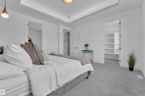 Bedroom featuring light gray carpeting, crisp white walls, and a recessed ceiling with accent lighting - 110 Eldridge Point(E), St. Albert, AB - Indoor Photo Showing Bedroom