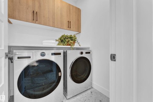 Dedicated laundry area featuring modern appliances and natural wood cabinetry - 110 Eldridge Point(E), St. Albert, AB - Indoor Photo Showing Laundry Room