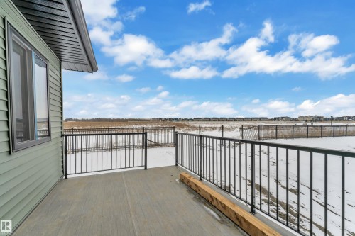 The property features a balcony with black railings and a concrete surface, offering views of a broad open expanse - 110 Eldridge Point(E), St. Albert, AB - Outdoor