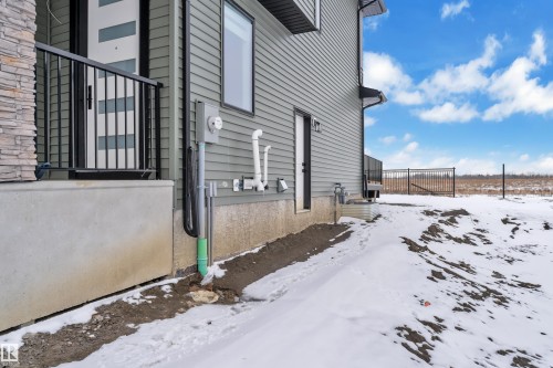 The property features a concrete foundation, a side entrance, and a deck with metal railings - 110 Eldridge Point(E), St. Albert, AB - Outdoor