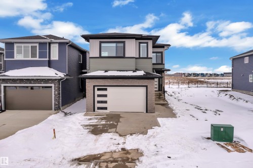 The property features a two-story design with a light-colored facade and a contrasting dark roof - 110 Eldridge Point(E), St. Albert, AB - Outdoor