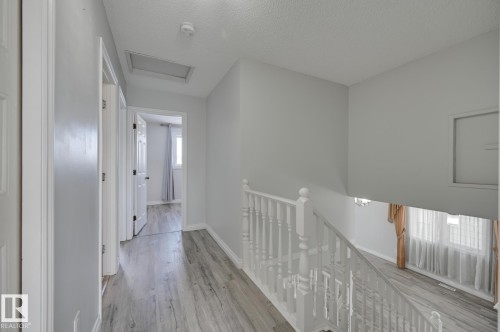 The property features light gray walls and wood-style flooring throughout - 8507 152B Avenue, Edmonton, AB - Indoor Photo Showing Other Room