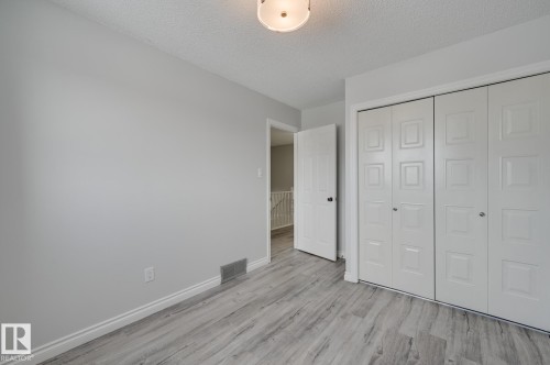 This room features light-colored walls and a light-toned wood-look floor - 8507 152B Avenue, Edmonton, AB - Indoor