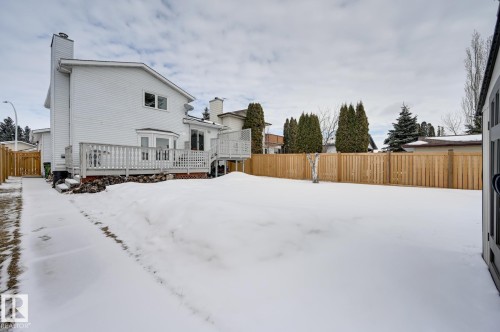 The property features a spacious backyard with a deck, a side path, and a wooden fence - 8507 152B Avenue, Edmonton, AB - Outdoor