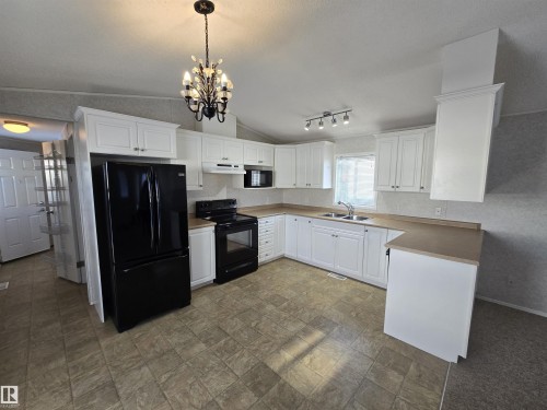 1133 Aspen Drive W, Leduc, AB - Indoor Photo Showing Kitchen With Double Sink