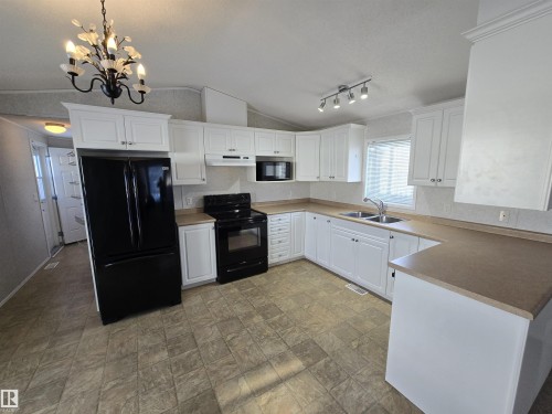 1133 Aspen Drive W, Leduc, AB - Indoor Photo Showing Kitchen With Double Sink