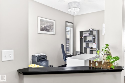 This area features light grey walls and a decorative chandelier - 1121 59A Street, Edmonton, AB - Indoor