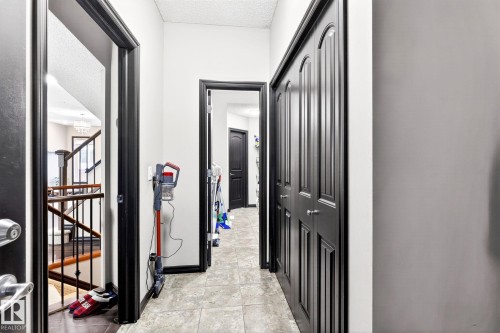 Hallway featuring dark paneled doors, light-colored walls, and tiled flooring - 1121 59A Street, Edmonton, AB - Indoor Photo Showing Other Room