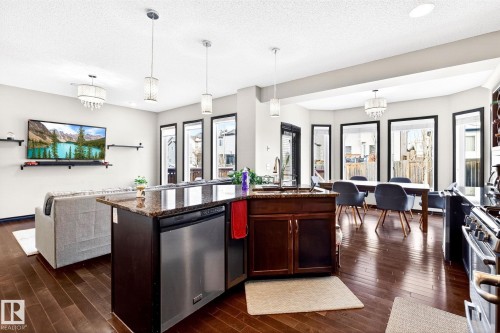 Open concept living area featuring dark hardwood flooring and light-colored walls - 1121 59A Street, Edmonton, AB - Indoor Photo Showing Kitchen With Double Sink With Upgraded Kitchen