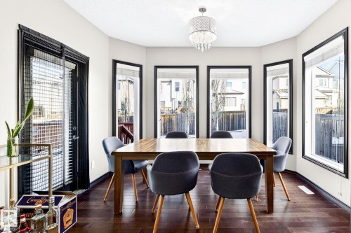 This dining area features hardwood floors and a chandelier - 1121 59A Street, Edmonton, AB - Indoor Photo Showing Dining Room
