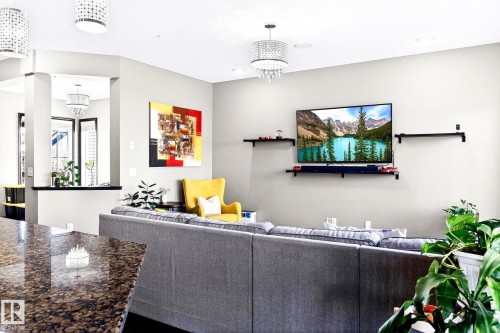 The living area features light-colored walls, a chandelier, and recessed lighting - 1121 59A Street, Edmonton, AB - Indoor
