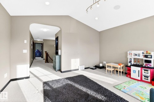 Spacious area featuring neutral-toned walls, recessed lighting, and light-colored carpeting - 1121 59A Street, Edmonton, AB - Indoor