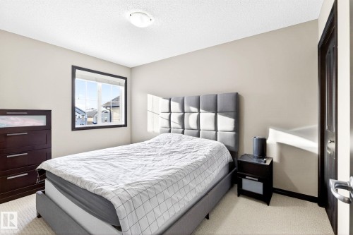 This room features a window providing natural light, light-colored walls, and carpeting - 1121 59A Street, Edmonton, AB - Indoor Photo Showing Bedroom