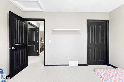 This room features light grey walls, dark trim, and light-colored carpet flooring - 1121 59A Street, Edmonton, AB - Indoor Photo Showing Bedroom