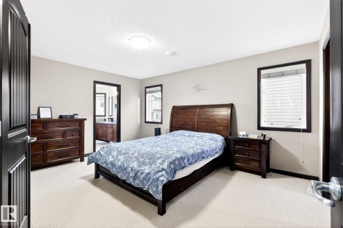 The room features neutral-toned walls, light-colored carpeting, and a ceiling light fixture - 1121 59A Street, Edmonton, AB - Indoor Photo Showing Bedroom