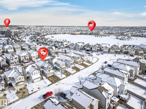 Aerial view of the community, showcasing residential properties with snow-covered roofs and streets - 1121 59A Street, Edmonton, AB - Outdoor With View