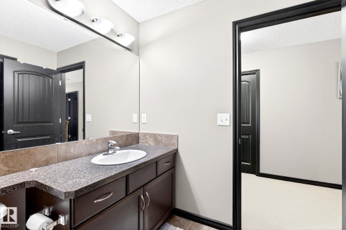 Bathroom featuring a vanity with a dark countertop and an undermount sink - 1121 59A Street, Edmonton, AB - Indoor Photo Showing Bathroom