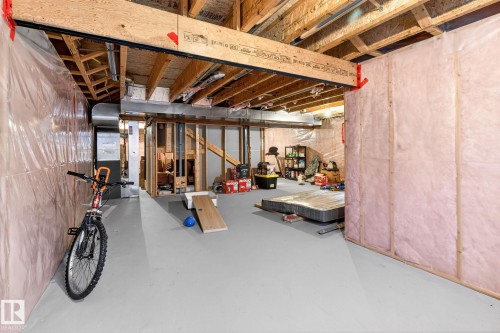 The basement features exposed wooden ceiling beams and a concrete floor - 1121 59A Street, Edmonton, AB - Indoor Photo Showing Basement