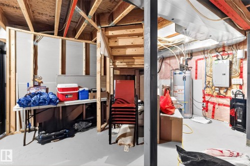 The property features an unfinished basement with visible wooden framing and ceiling joists - 1121 59A Street, Edmonton, AB - Indoor Photo Showing Basement