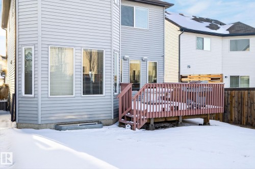 The property features a private deck with wooden railings, providing an outdoor living space - 1121 59A Street, Edmonton, AB - Outdoor With Exterior