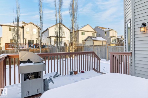 The property features a wooden deck with a wooden railing and steps leading to the yard - 1121 59A Street, Edmonton, AB - Outdoor With Deck Patio Veranda With Exterior