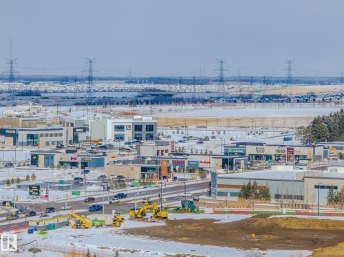 View of the community, featuring commercial buildings, roads, and a large undeveloped area - 1121 59A Street, Edmonton, AB - Outdoor With View