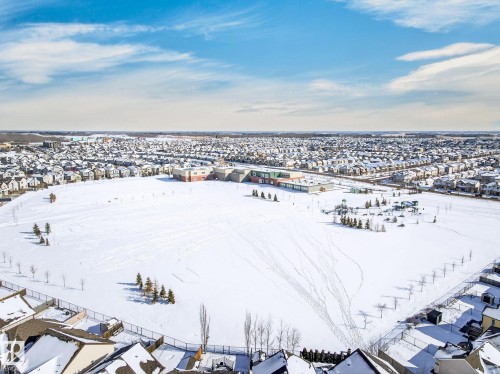 Aerial view showcasing the expansive snow-covered field and surrounding residential properties - 1121 59A Street, Edmonton, AB - Outdoor With View