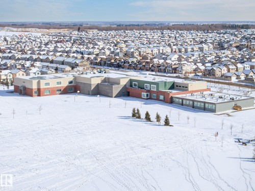 Aerial view showcasing the neighborhood and surrounding area, featuring numerous residential properties with snow-covered rooftops - 1121 59A Street, Edmonton, AB - Outdoor With View