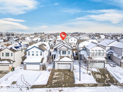 This property features a contemporary architectural style, an attached garage, and a paved driveway - 1121 59A Street, Edmonton, AB - Outdoor With Facade