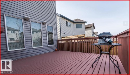 Spacious outdoor deck with rich red-toned wood flooring and matching wood railings - 1121 59A Street, Edmonton, AB - Outdoor With Deck Patio Veranda With Exterior