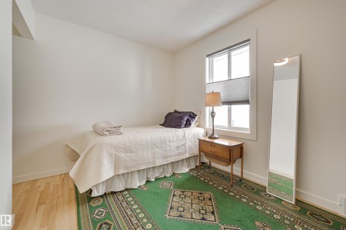 This room features light-colored walls and a window with blinds, allowing for natural illumination - 11116 52 Street Nw, Edmonton, AB - Indoor Photo Showing Bedroom