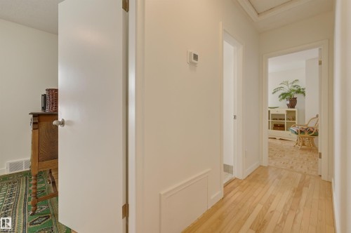 Hallway featuring light wood flooring, white walls, and white trim - 11116 52 Street Nw, Edmonton, AB - Indoor Photo Showing Other Room
