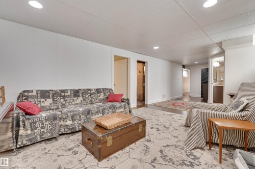 This spacious living area features recessed lighting and a decorative area rug - 11116 52 Street Nw, Edmonton, AB - Indoor