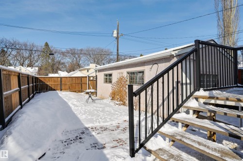 The property features a fenced yard with a partially paved patio area - 11116 52 Street Nw, Edmonton, AB - Outdoor